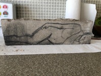 a concrete block with a drawing of a woman on it