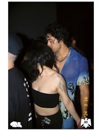 a man and a woman standing next to each other at a party