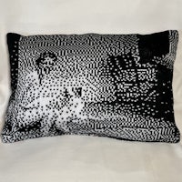 a black and white pillow with a picture of a woman on it