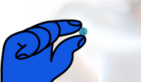 a hand is holding a blue object in front of a light