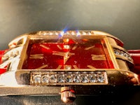a red leather watch with diamonds on it
