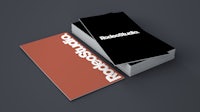 a stack of business cards on a black background