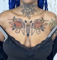 a woman with dreadlocks and tattoos on her chest