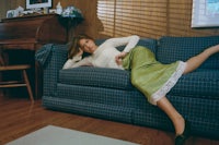 a woman laying on a couch in a living room