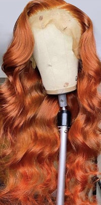 orange wavy lace front wig on a mannequin