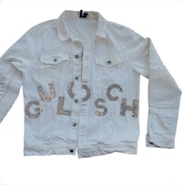 a white denim jacket with sequins on it