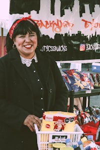 a woman standing in front of a basket of food