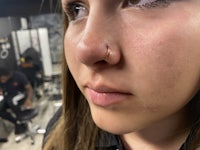 a woman with a nose piercing in a salon
