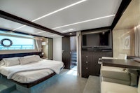 a bedroom on a luxury yacht with a bed and tv