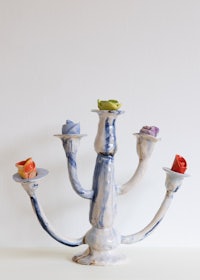 a blue and white ceramic candelabra on a table