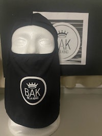 a mannequin wearing a balaclava with the bak logo on it