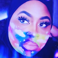 a woman's face painted with rainbows and clouds