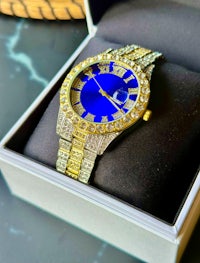 a blue and gold watch in a box