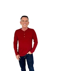 a man wearing a red henley shirt and jeans