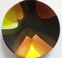 a plate with a yellow, orange, and brown design
