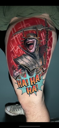 a man with a comic book tattoo on his thigh