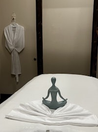 a massage room with a statue on top of a bed