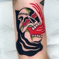 a tattoo of a skull with a red and green design