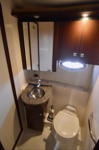 a bathroom with a sink and toilet in a small boat