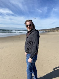 a man standing on a sandy beach