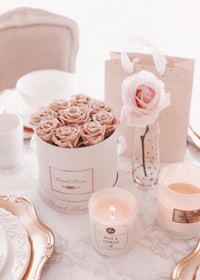 a table setting with candles and roses