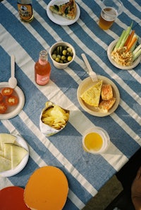 a table full of food on a blue and white striped tablecloth
