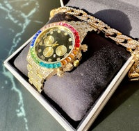 a watch in a box with a rainbow colored dial