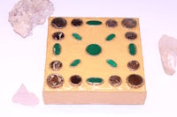 a yellow box with stones and crystals on it