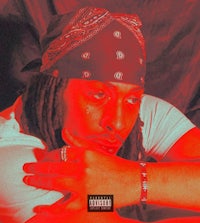 a man with dreadlocks and a bandana is posing in front of a red background