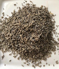 a pile of dried lavender seeds on a white plate