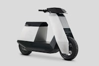 a white and black electric scooter on a gray background