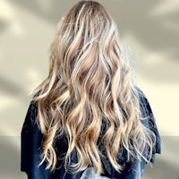 the back of a woman's hair with long wavy hair