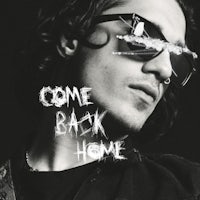 a man in sunglasses with the words come back home