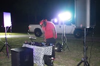 a man standing in front of a dj booth