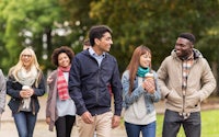 a group of people walking together in a park