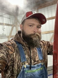 a bearded man wearing overalls and a beard