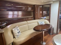 the interior of a boat with a couch and table