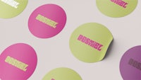 a group of colorful round stickers with the word bossz on them