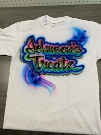 a white t - shirt with a graffiti design on it