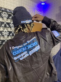 a person wearing a jacket with a logo on it