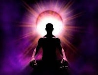 a man sitting in meditation in front of a purple light