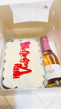 a box with a cake and a bottle of champagne