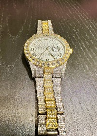 a gold and diamond watch on a table