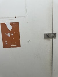 a white door with an orange sticker on it