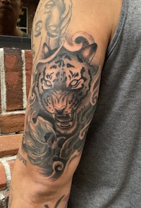 a tiger tattoo on a man's arm