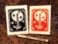 two cards with a candle on them