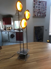 three lamps on a table in a kitchen