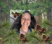 a photo of a woman in a forest with pine cones