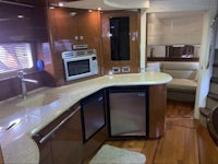 the interior of a boat with a microwave and refrigerator