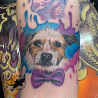 a tattoo of a dog with a bow tie